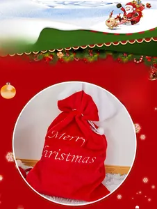 Detail of red plush Christmas gift bag with white Merry Christmas embroidery and drawstring