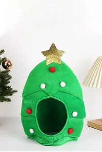 Close-up of green plush Christmas tree hat with gold star and colorful pom-poms