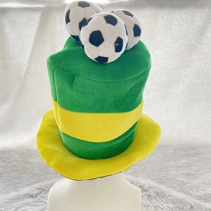 Detail of football fan top hat with green and yellow panels and plush soccer ball accents