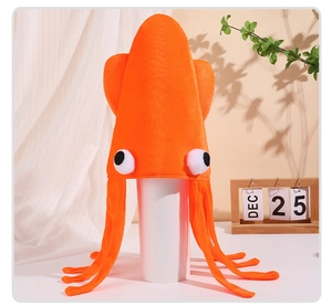 Detail of orange velvet squid hat with large eyes and tentacles on a festive stand
