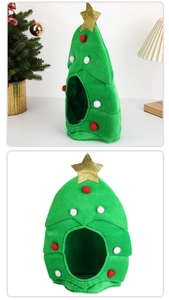 Close-up of green plush Christmas tree pet hat with gold star and colorful pom-poms