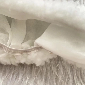 Detailed close-up of plush white Christmas hat fabric with durable elastic band