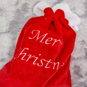 Large red plush Christmas gift bag with white Merry Christmas embroidery and drawstring