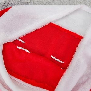 Red knit Christmas gift bag with white faux fur trim and braided rope details