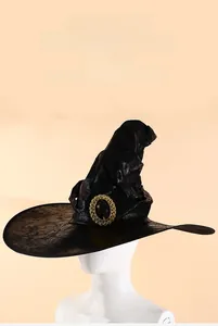 Detail of black glossy witch hat featuring a gold buckle and textured magic wizard fabric