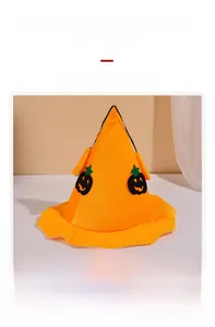 Close-up of velvet Halloween wizard hat with orange finish and cartoon pumpkin patches