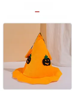 Detail of bright orange Halloween witch hat with black pumpkin face patterns
