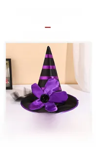 Detail of a purple satin flower with black sequins on a striped Halloween witch hat