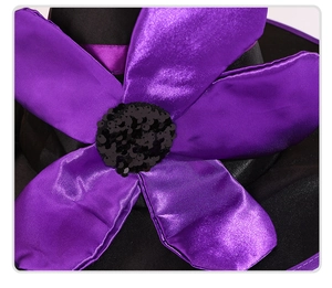 Close-up of purple satin flower with black sequins on Halloween witch hat decor