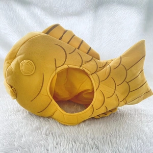 Detailed view of the yellow plush fish headgear showing soft scales and fin embroidery