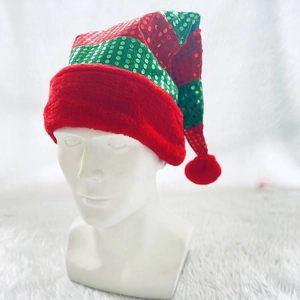Christmas elf hat with red and green sequins and white faux fur trim on a display mannequin