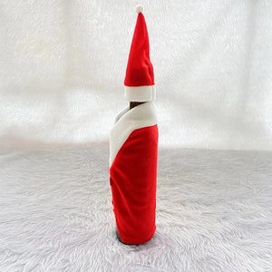 Detailed view of red velvet Santa suit wine bottle cover with soft white faux fur collar