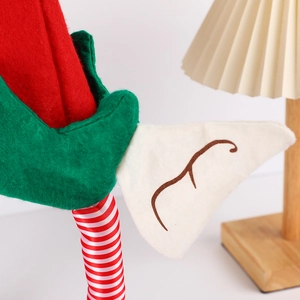 Handcrafted Christmas elf hat ornament with red green felt and striped fabric legs