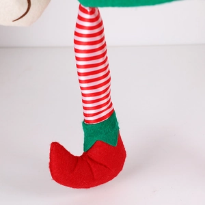 Christmas elf legs decor with red white striped stockings and pointed elf shoes