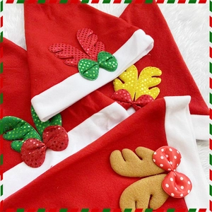 Detail of Christmas hats with colorful sequined reindeer antlers and plush white trim