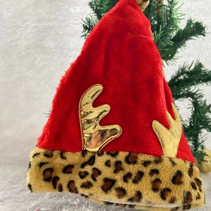 Creative red plush Christmas hat with golden reindeer antlers and leopard print brim detail