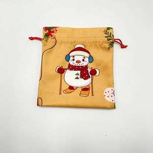 Detail view of snowman pattern on festive orange Christmas drawstring gift bag