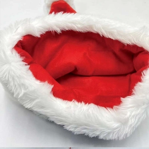 Close-up of thick red velvet fabric and white faux fur trim on a Christmas hat