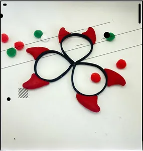 Close-up of three pieces set of red devil horn hair ties with elastic black bands