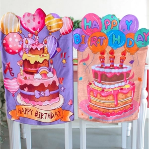 Pair of colorful Happy Birthday chair covers with cake and balloon patterns on white chairs