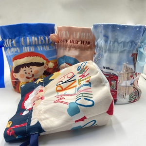 Detailed view of Christmas drawstring gift bags with festive Santa and winter illustrations
