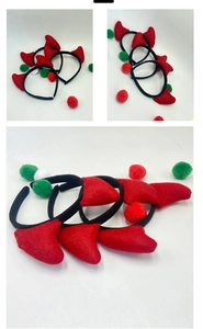 Detailed view of red devil horn headband with colorful pom-poms for Halloween parties