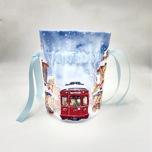 Detail of canvas drawstring gift bag with a vintage red tram winter scene print