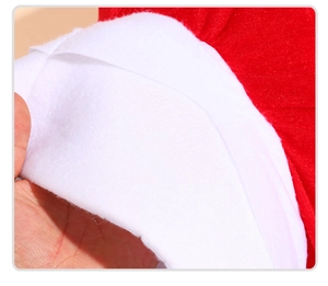 Detail of red plush fabric and thick white faux sheepskin texture on mushroom hat