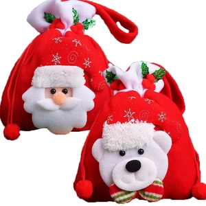 Close-up of Santa and Polar Bear Christmas drawstring gift bags with plush pom-poms