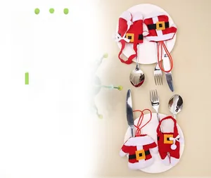 Macro shot of miniature Christmas sweater cutlery holder on a white ceramic plate