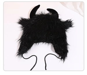 Detailed view of black faux fur devil horn hat with ear flaps and soft tie straps