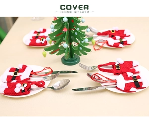 Detail of knitted Santa clothes and trousers cutlery holders for Christmas table decor