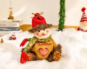 Detail of Christmas snowman gift bag with clear heart window showing a fresh apple inside