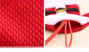 Detail of red knitted Christmas cutlery holder showing the fabric texture and drawstring