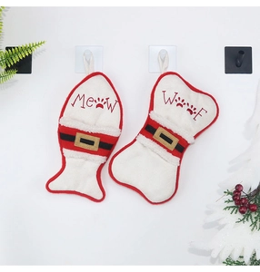 Detail of red flannel fish and bone pet Christmas stockings with Meow and Woof prints