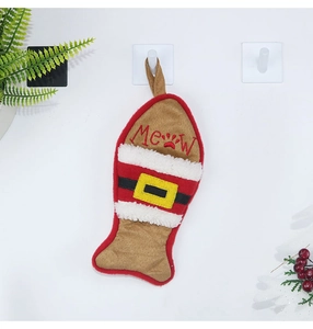 Close-up of fish-shaped Christmas stocking with Meow embroidery and lamb wool detail