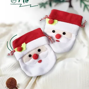 Detailed close-up of Christmas Santa drawstring gift bags made of soft red and white fabric