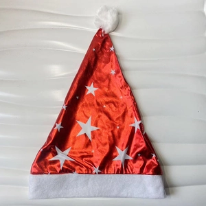 Detail of red metallic Christmas hat with white star prints and soft plush trim