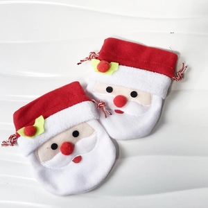Detail view of Santa Claus drawstring gift bags with plush fabric and 3D nose ornaments