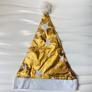Detail of a golden Christmas hat with white star patterns and soft plush trim