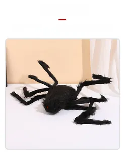 Detailed view of large black plush spider with red eyes for Halloween outdoor decoration