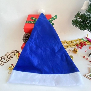 Blue plush Christmas hat with white pompom featured among festive gift boxes and decor