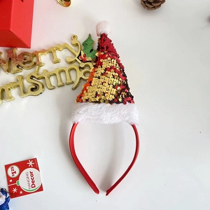 Christmas headband with red and gold sequin Santa hat on white background with festive decor