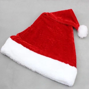 Classic red plush Christmas hat with white faux fur trim and pompom on grey background