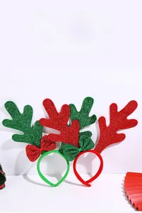Detail of Christmas reindeer antler headband with glitter bow and plush texture