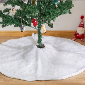 Plush white faux fur Christmas tree skirt on wooden floor with festive dwarf decoration