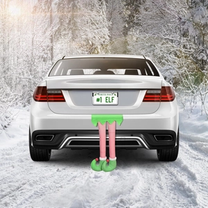 Détail de jambes de lutin en peluche sur un coffre de voiture sous une forêt enneigée