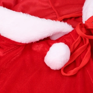Macro detail of Christmas hooded cape showing red velvet fabric and white fur trim