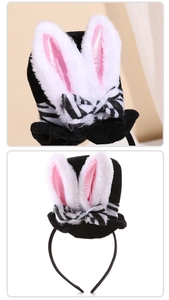 Detailed close-up of plush rabbit ears with striped bow on a mini party top hat headband