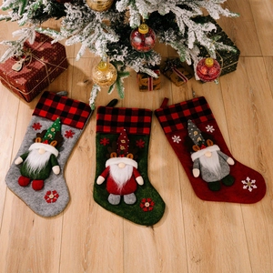 Three premium 3D gnome Christmas stockings with buffalo plaid cuffs and reindeer antlers